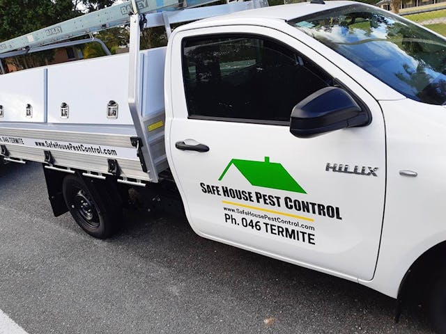 Safe House pest control ute with door decal